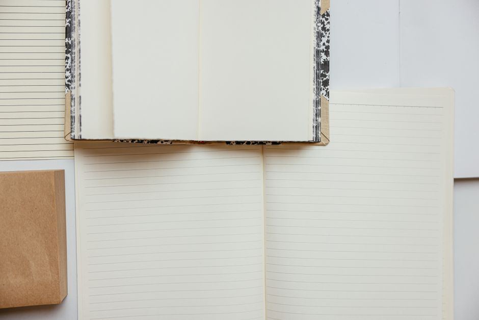 An open notebook and reference book on a desk.